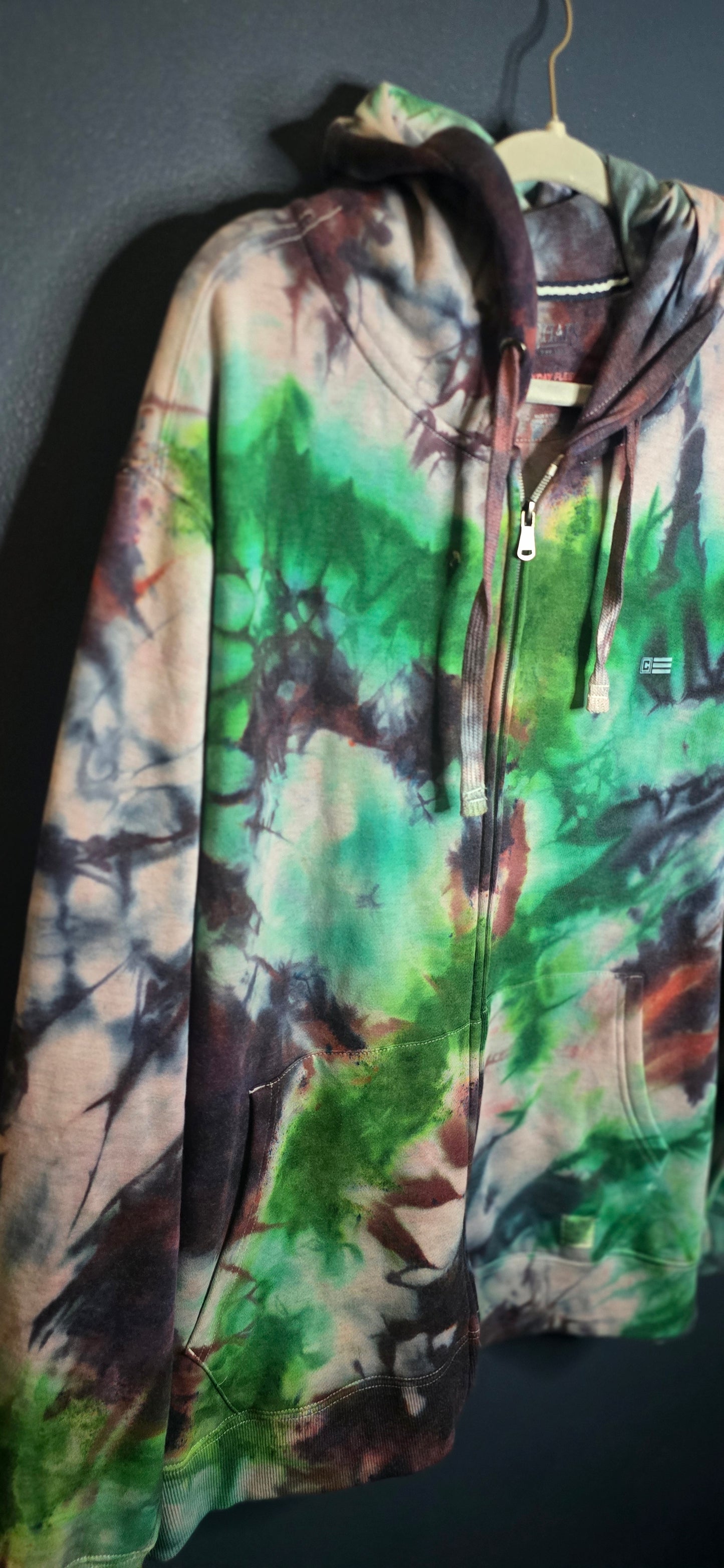 Tie-dye pants with a multicolor pattern on a dark surface